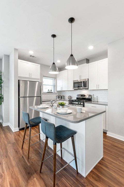 Designer apartment kitchen in Chester Springs, PA with large island and gray quartz counters